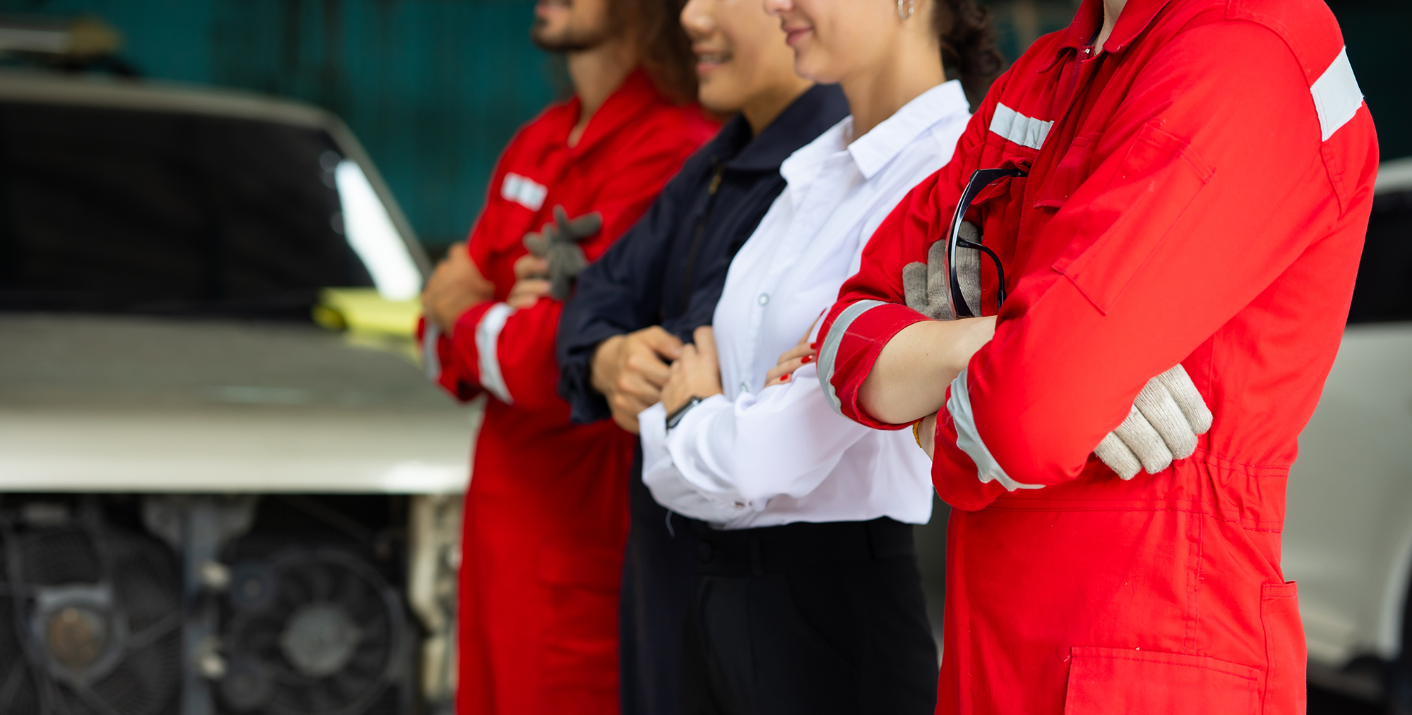 side view of mechanic team standing side by side